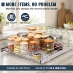 A chrome-plated steel under-cabinet kitchen organizer tray holding clear glass jars with wooden lids and glass bottles, shown installed on a kitchen counter with promotional text overlays. Heavy-Duty Pull-Out Cabinet Organizer. Vitly Hub