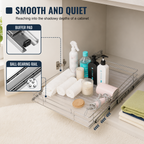 A pull-out cabinet organizer tray shown inside an open bathroom or utility cabinet, holding toiletries and towels. The image includes callout panels explaining the buffer pad and ball-bearing rail features. Heavy-Duty Pull-Out Cabinet Organizer. Vitly Hub