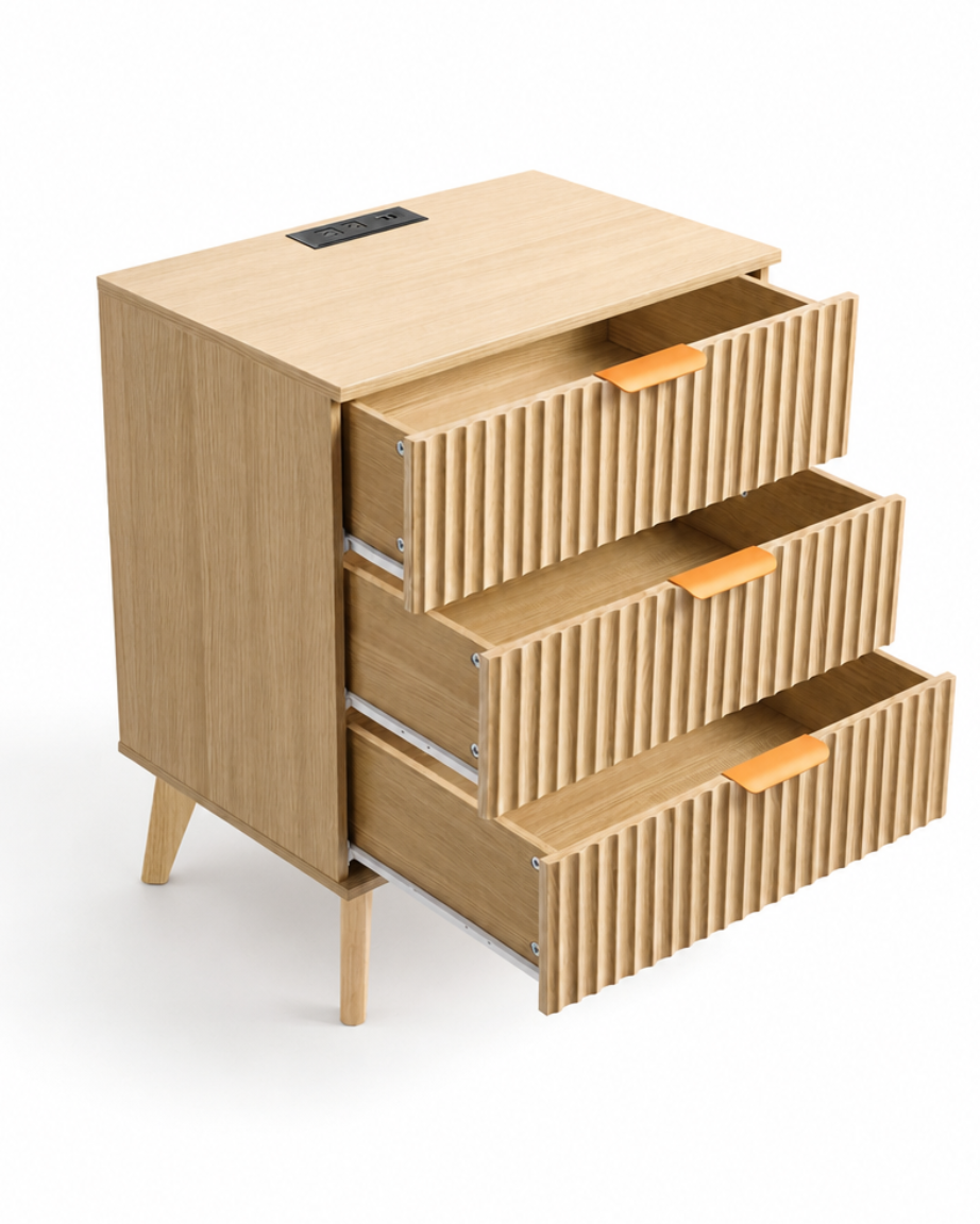 A modern three-drawer wooden nightstand or cabinet with a light natural wood finish, featuring vertically ribbed drawer fronts, angled legs, and small orange pull tabs, shown on a white background with two drawers partially open.