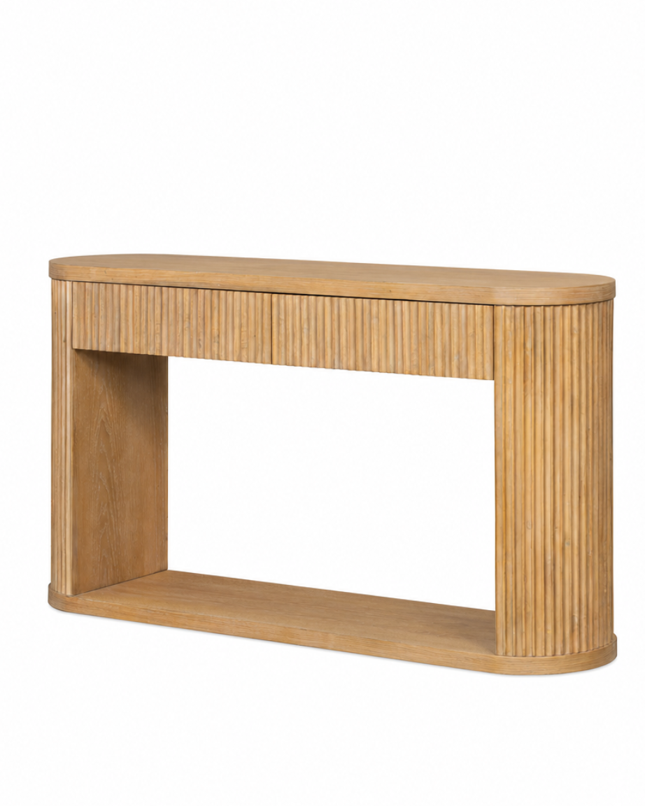 A light oak wood console table with a fluted front and rounded ends, shown from a three-quarters angle on a white background.
