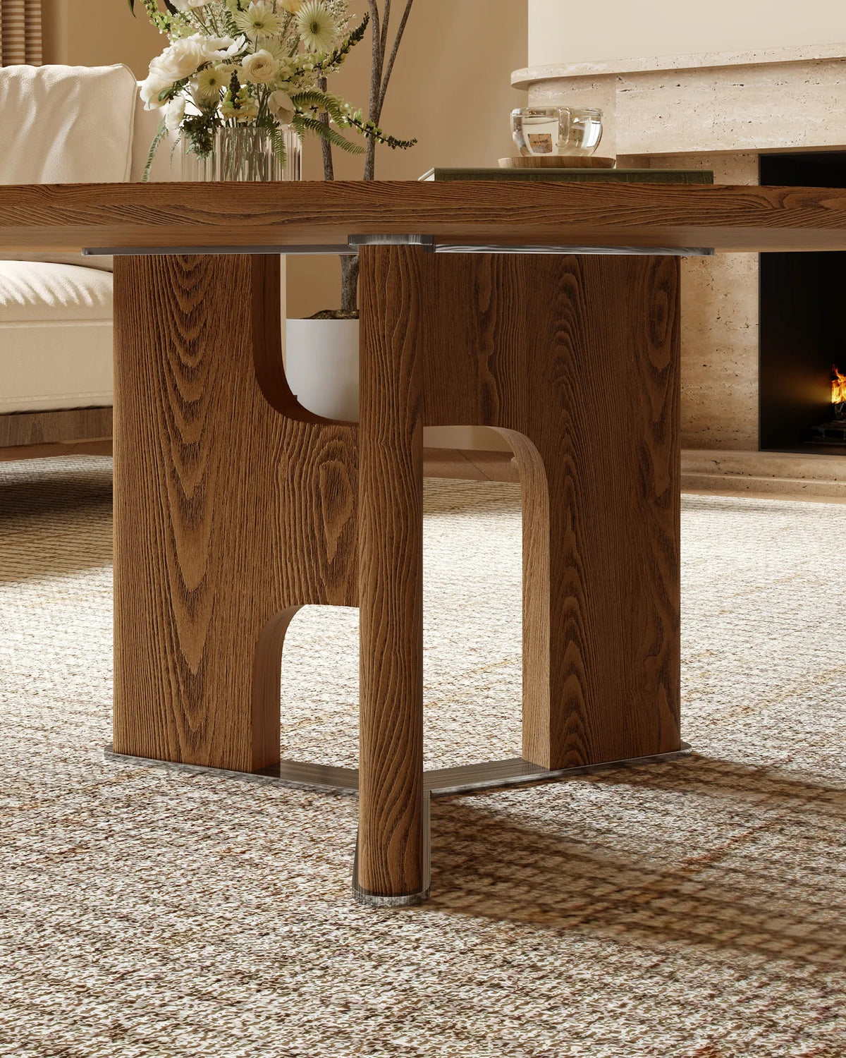 Wooden dining table in a living room setting with a fireplace in the background.