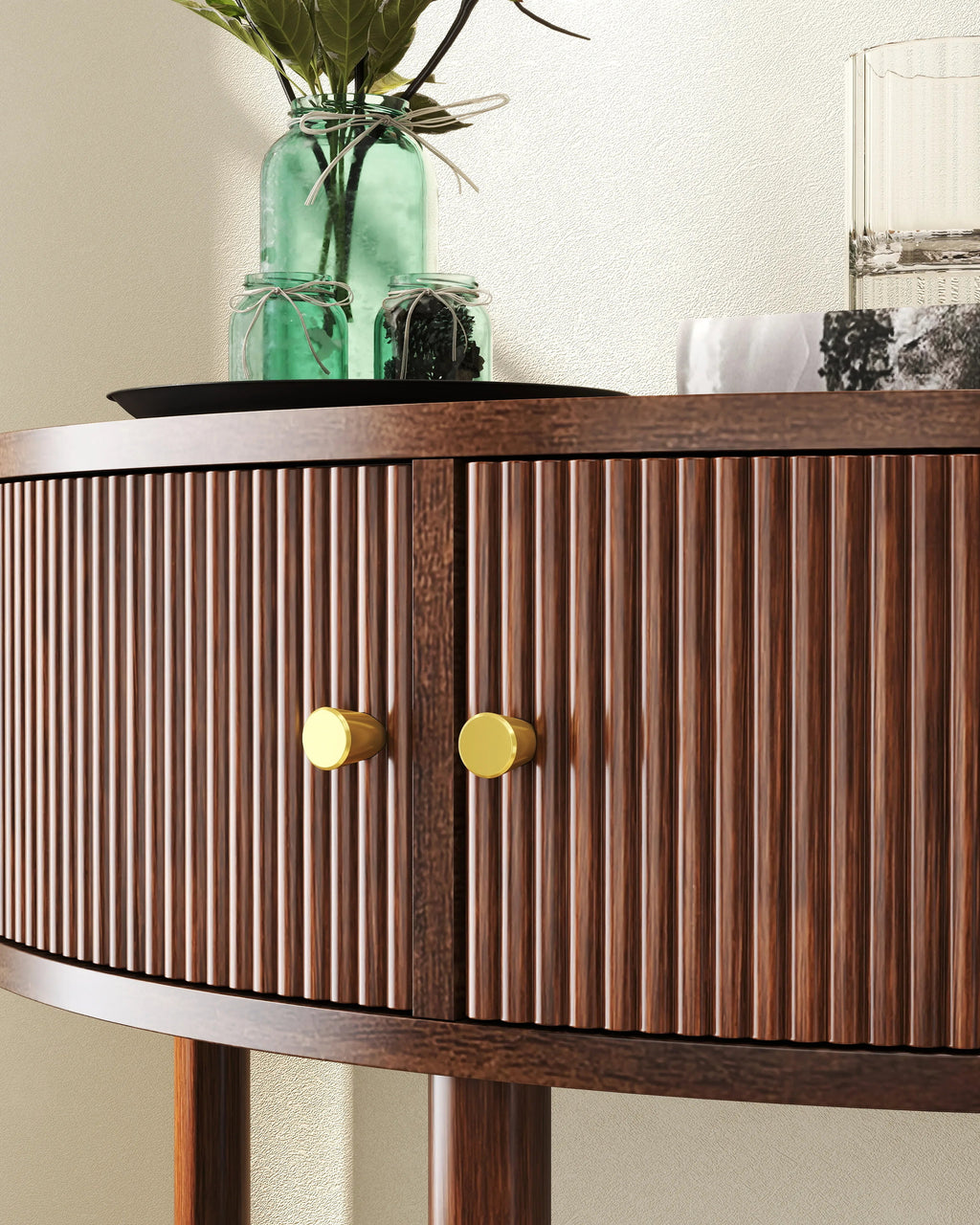 Wooden sideboard with two gold handles against a neutral wall.