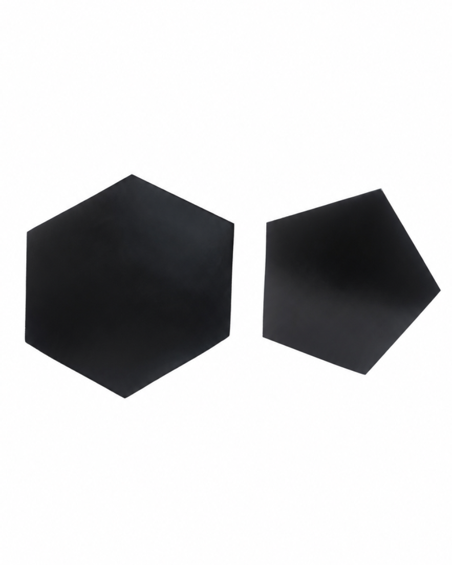 Two matte black geometric wall decals, one hexagonal and one pentagonal, displayed on a solid white background.