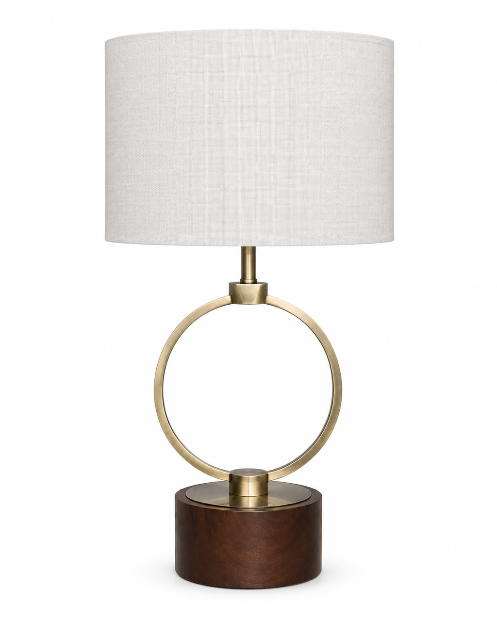 A modern table lamp featuring a cylindrical white linen shade, a polished brass circular ring and central finial, and a round dark brown wooden base, shown against a plain white background.