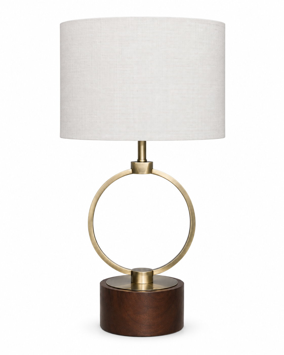 A modern table lamp featuring a cylindrical white linen shade, a polished brass circular ring and central finial, and a round dark brown wooden base, shown against a plain white background.
